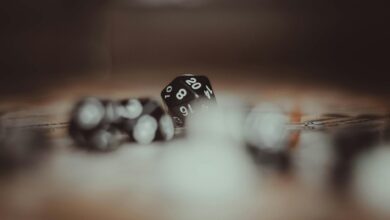 Artistic photo of multi-sided gaming dice in a blurred setting, highlighting the number 20.