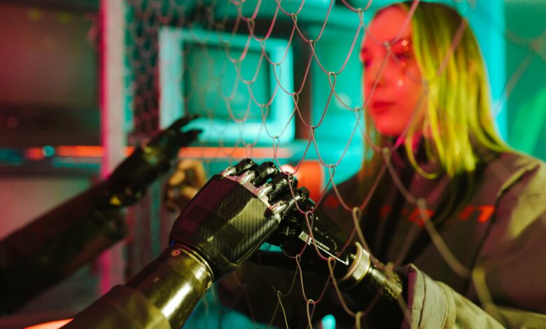 A woman interacts with robotic hands through a mesh displaying a neon cyberpunk atmosphere.