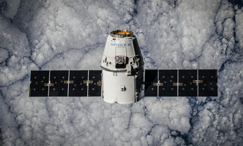 SpaceX Dragon spacecraft in orbit, highlighting advanced space technology with cloud backdrop.