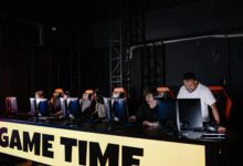 Esports team engaged in competitive gaming session indoors, showcasing teamwork and concentration.