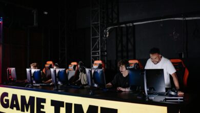 Esports team engaged in competitive gaming session indoors, showcasing teamwork and concentration.