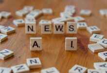 Wooden Scrabble tiles spelling 'AI' and 'NEWS' for a tech concept image.