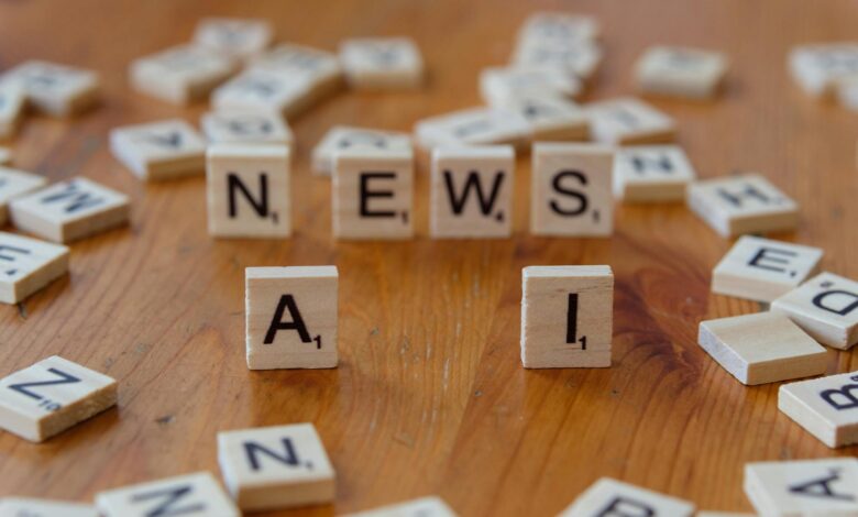 Wooden Scrabble tiles spelling 'AI' and 'NEWS' for a tech concept image.