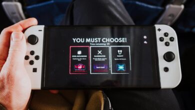 Close-up of a person holding a gaming console with an on-screen decision prompt.