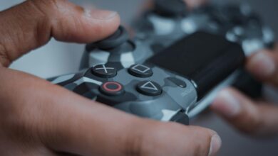 Detailed shot of hands gripping a camouflage game controller, perfect for gaming themes.