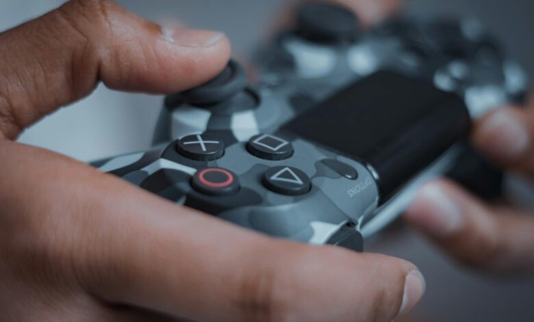 Detailed shot of hands gripping a camouflage game controller, perfect for gaming themes.