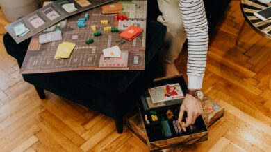 Close-up of a strategic board game with colorful pieces in a cozy indoor space.