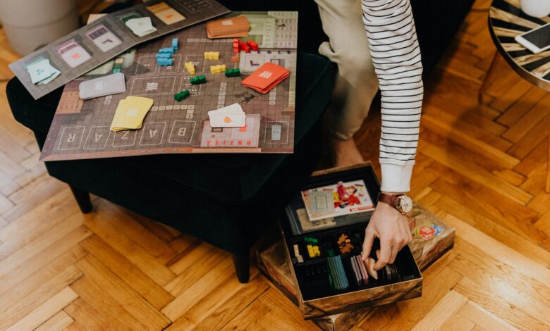 Close-up of a strategic board game with colorful pieces in a cozy indoor space.