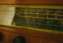 Close-up of a vintage radio tuner displaying frequency dials.