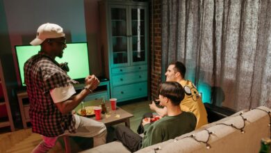 Three friends playing video games together in a cozy home setting.