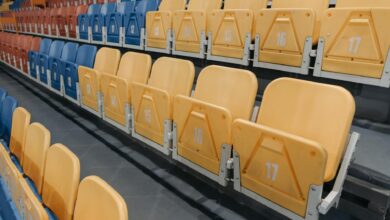 Colorful empty seats in a stadium bleachers perfect for sports events and concerts.