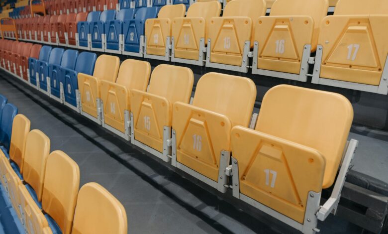 Colorful empty seats in a stadium bleachers perfect for sports events and concerts.