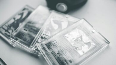 Close-up of collectible Pokemon cards in protective cases, emphasizing preservation and value.