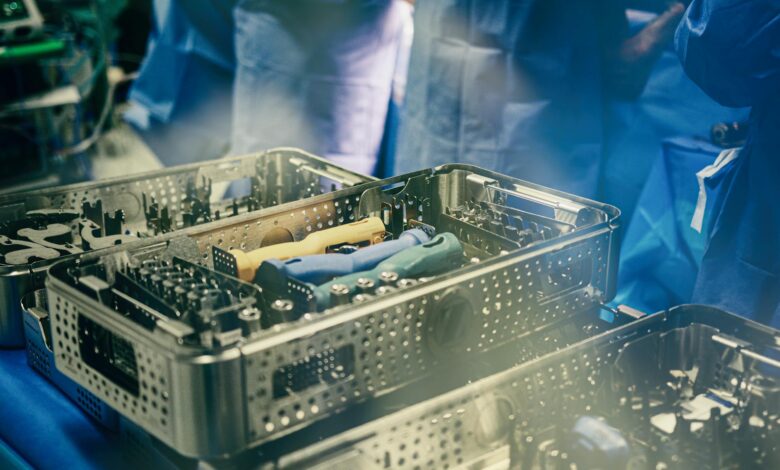 Close-up of sterilization trays containing surgical instruments in a medical setting.