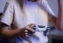 Person playing video games with game controller in a relaxed setting.