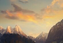 Breathtaking view of snowcapped mountains under a beautiful sunset sky.