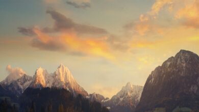 Breathtaking view of snowcapped mountains under a beautiful sunset sky.