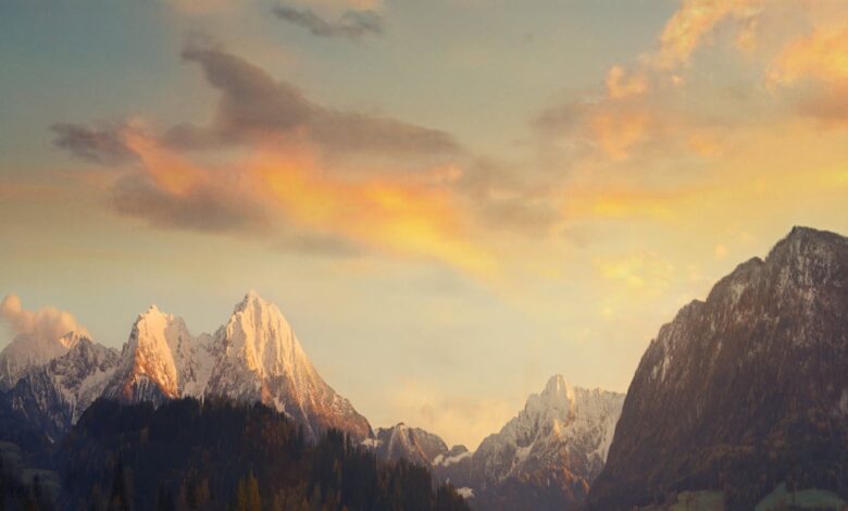 Breathtaking view of snowcapped mountains under a beautiful sunset sky.