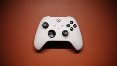 White Xbox controller isolated on a red background with shadows.