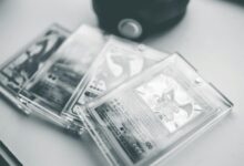 Close-up of collectible Pokemon cards in protective cases, emphasizing preservation and value.