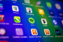 Blurred close-up of vibrant app icons on a smartphone screen showcasing Spotify and more.