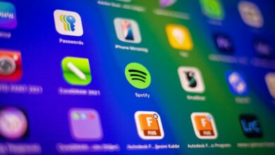 Blurred close-up of vibrant app icons on a smartphone screen showcasing Spotify and more.