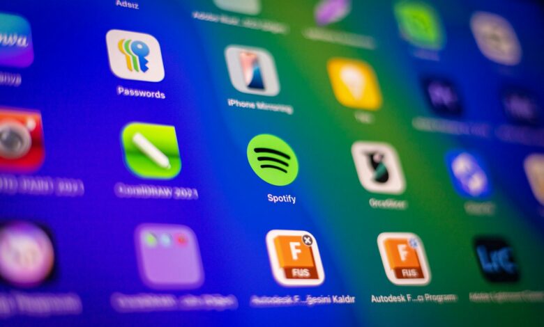 Blurred close-up of vibrant app icons on a smartphone screen showcasing Spotify and more.