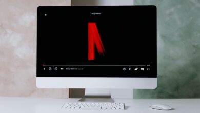 Modern desktop setup featuring streaming on a sleek monitor with keyboard and mouse.