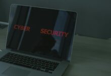 Close-up of a laptop displaying cybersecurity text, emphasizing digital security themes.