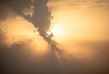 Beautiful sunset with dramatic clouds and golden hues. Captured outdoors, perfect for nature themes.