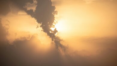 Beautiful sunset with dramatic clouds and golden hues. Captured outdoors, perfect for nature themes.