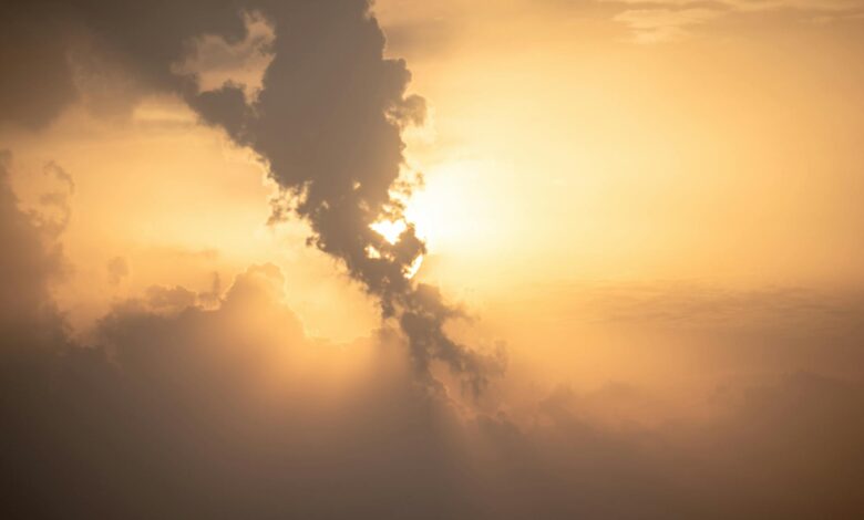 Beautiful sunset with dramatic clouds and golden hues. Captured outdoors, perfect for nature themes.