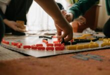 Friends enjoying a strategic board game session indoors, focusing on gameplay and fun interaction.