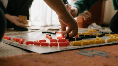 Friends enjoying a strategic board game session indoors, focusing on gameplay and fun interaction.