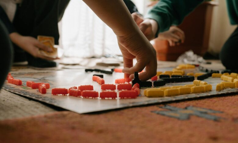 Friends enjoying a strategic board game session indoors, focusing on gameplay and fun interaction.
