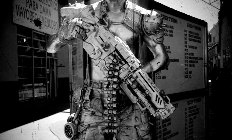 A black and white image of a cyberpunk soldier character in Tijuana, Mexico, holding a futuristic weapon.