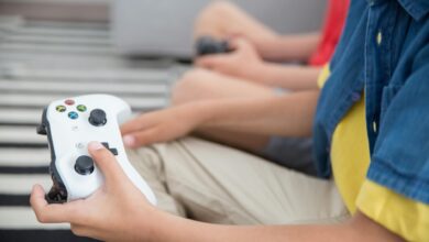 Two children playing video games with controllers, indoors, showcasing fun and technology.