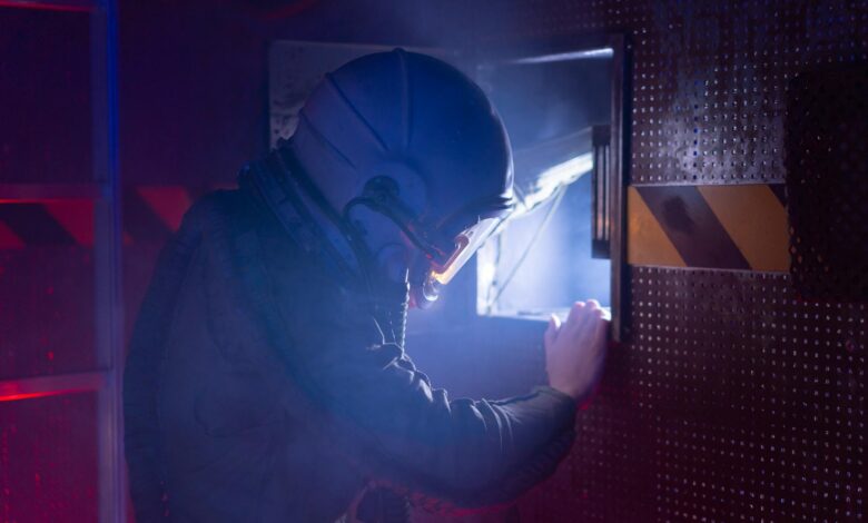 A woman astronaut in a space suit exploring a futuristic spacecraft interior with atmospheric lighting.