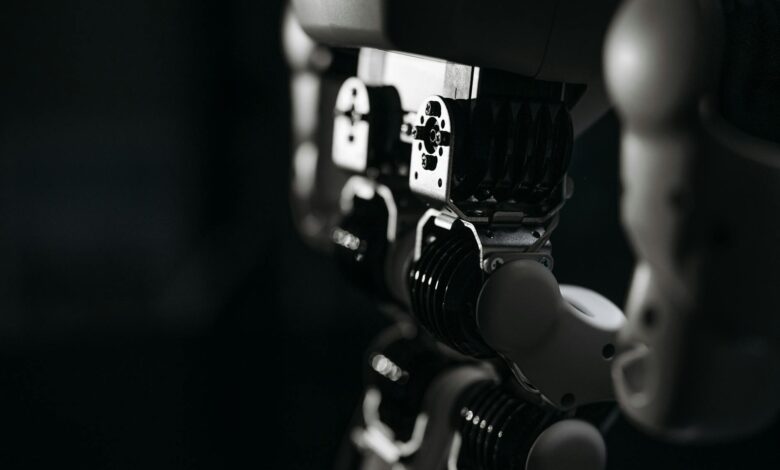 Detailed close-up of a robot's mechanical components, emphasized by moody studio lighting.