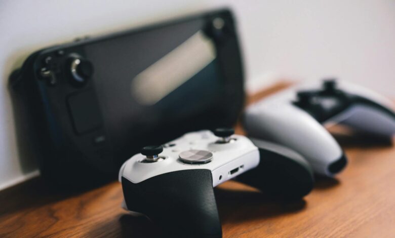 Stylish setup of gaming controllers and console on wooden surface.
