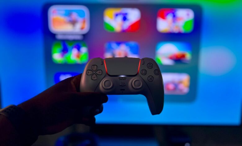 Close-up of a gaming controller against a vibrant screen in London, England.