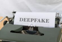 Old-fashioned typewriter with a paper labeled 'DEEPFAKE', symbolizing AI-generated content.