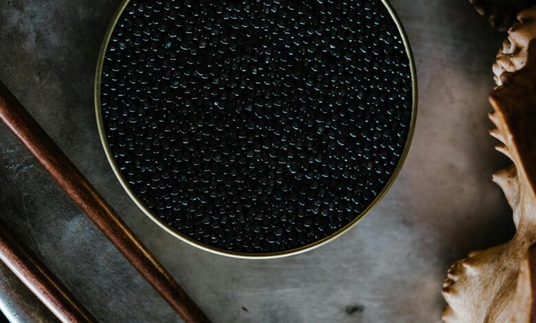Close-up of black caviar in a tin, showcased with a rustic culinary aesthetic.