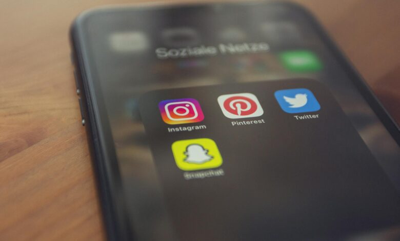 Smartphone displaying popular social media apps like Instagram, Pinterest, Twitter, and Snapchat.
