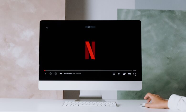 A minimalist workspace scene featuring a desktop displaying a streaming service, ideal for modern lifestyle themes.