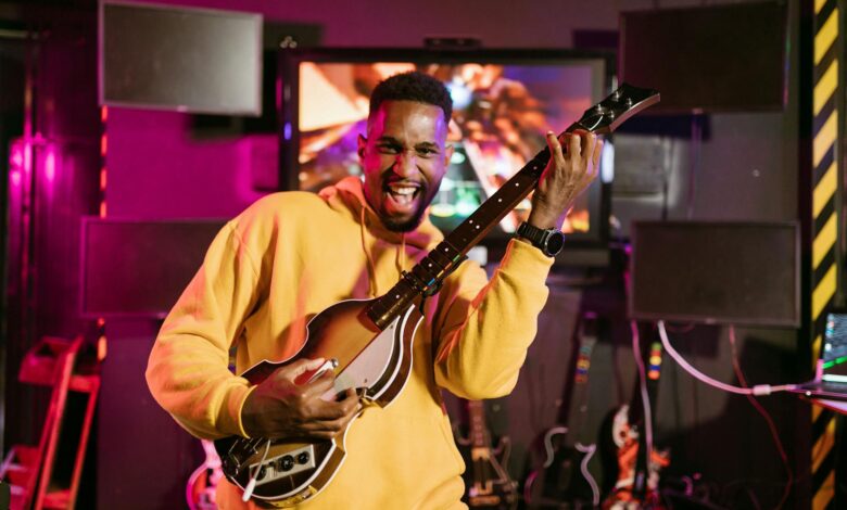 A cheerful adult playing Guitar Hero indoors, exuding excitement and happiness.