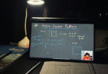 A dimly lit home study setup with laptop displaying coding notes on a hollow square pattern.