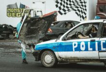 Stunt performers managing a police car scene at a thrilling event.