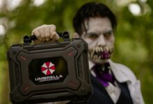 A cosplayer holding an Umbrella Corporation case, inspired by Resident Evil, ready for Halloween.