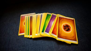 From above of colorful pack of trading cards for game placed on gray surface